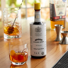 Cocktail glass with Angostura bitters suggesting balanced flavors.