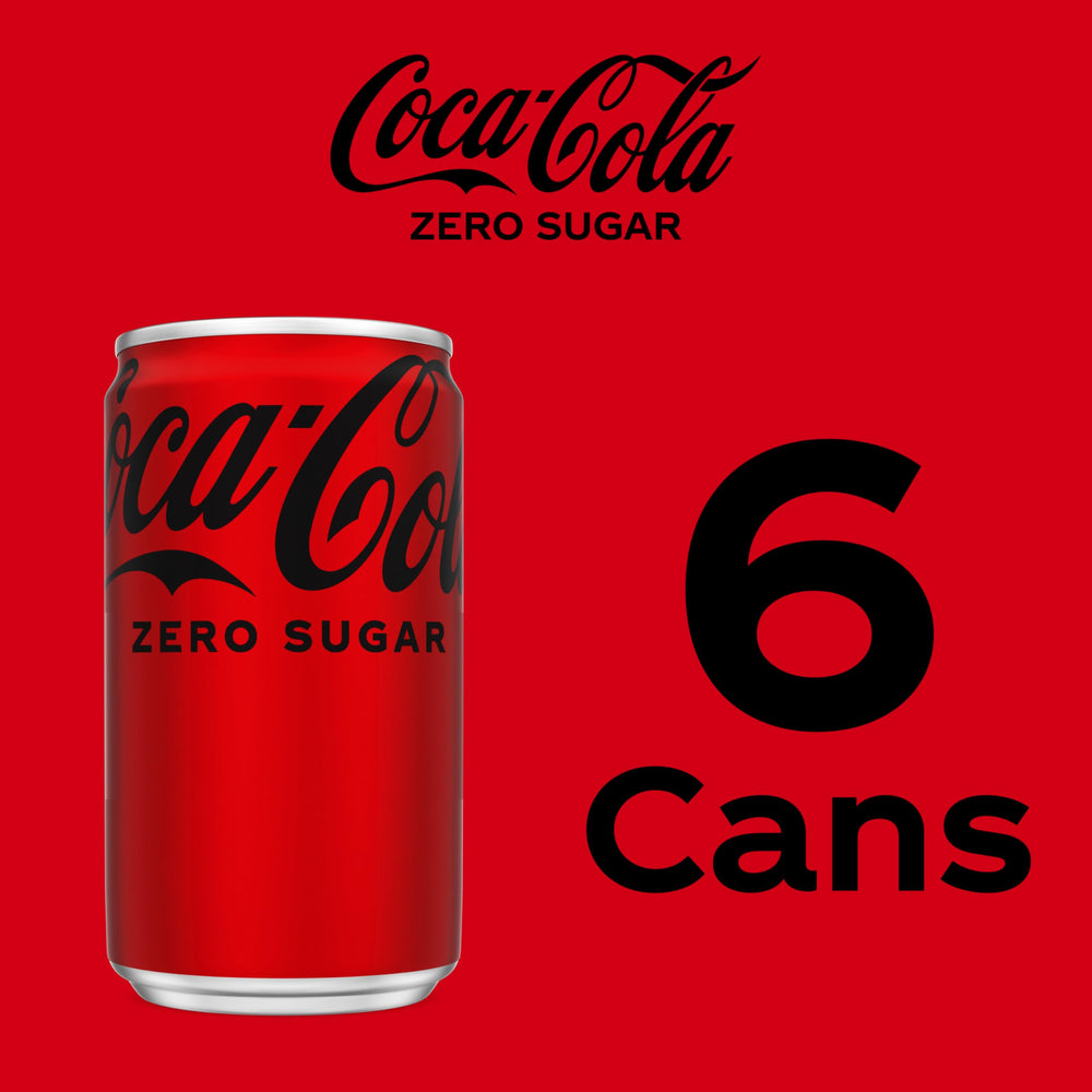 Coke Zero Sugar mini-can bubbles rise in a chilled glass.