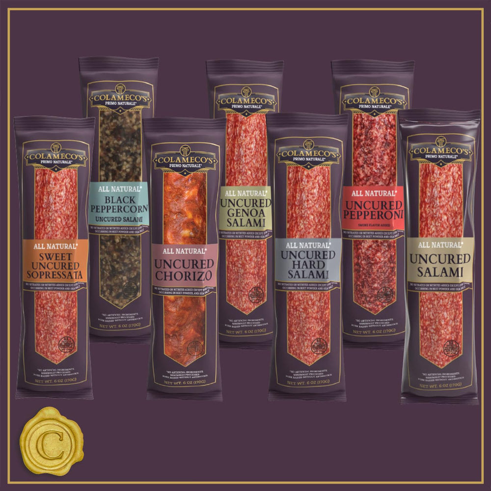 Colamecos salami with cheese and olives on a snack board.