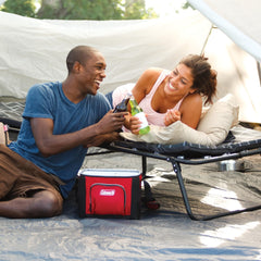 Coleman ComfortSmart cot with pull-out side tables keeps essentials within reach.