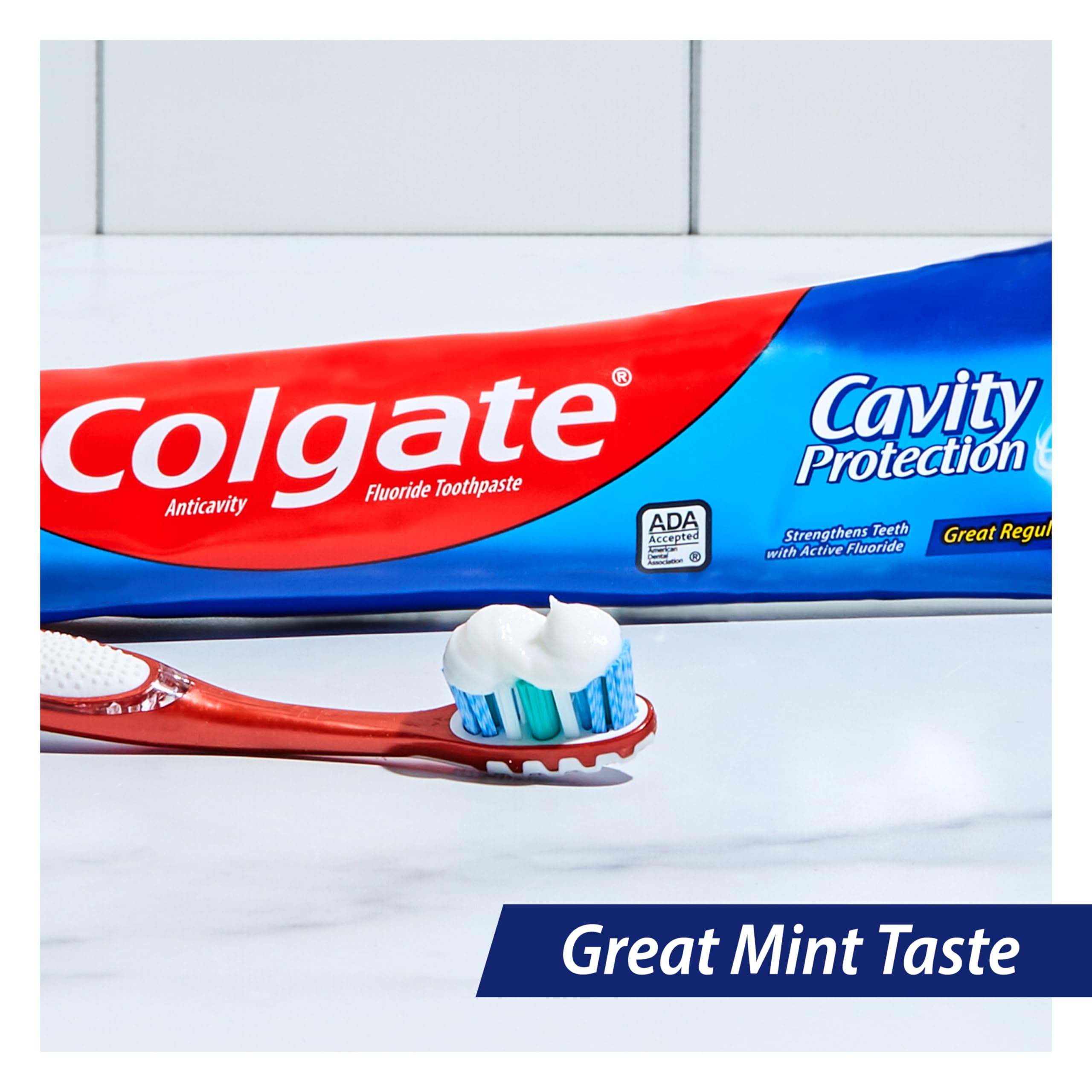 Colgate Cavity Protection toothpaste mint tube being dispensed for brushing