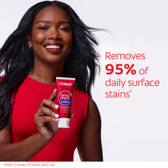 Colgate Optic White Purple toothpaste being squeezed with mint foam.