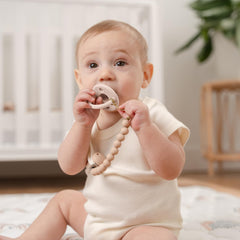Comfy Cubs pacifier clip beige side view showing secure attachment