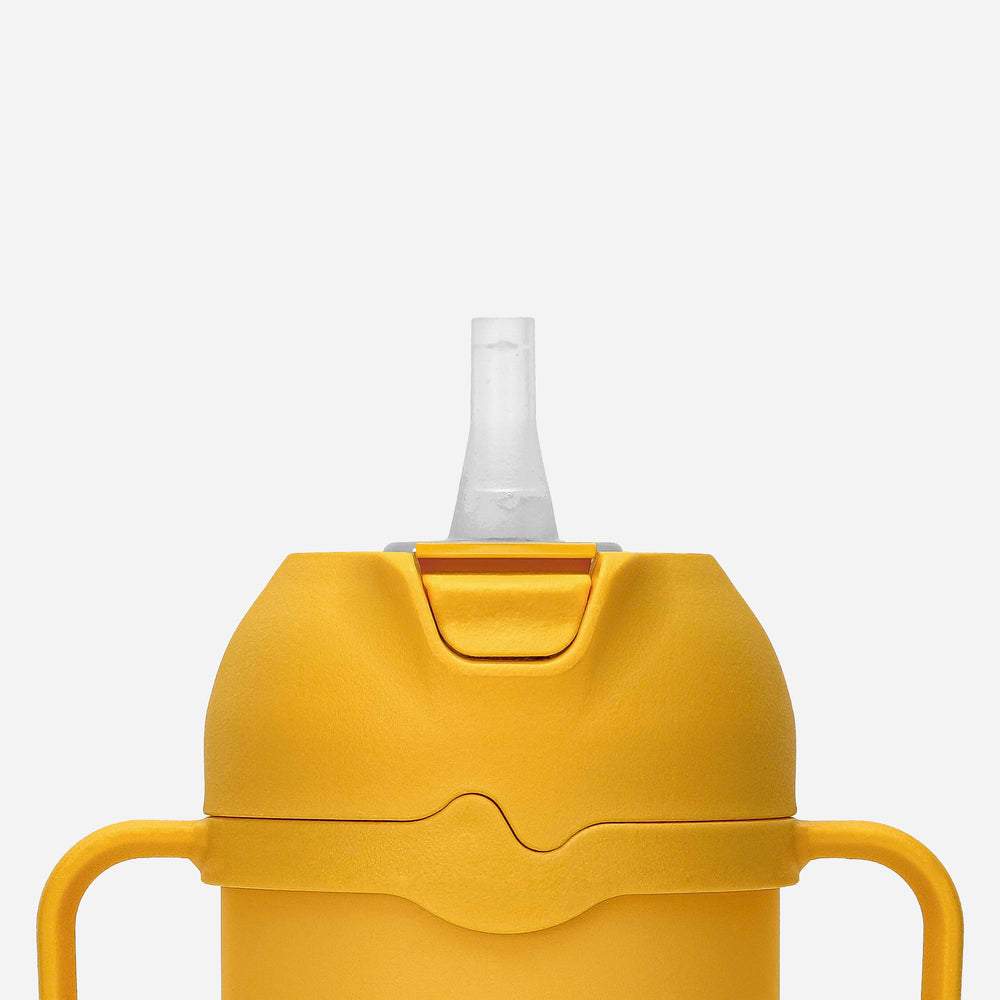 Comotomo Toddler Tumbler yellow spout offers easy sip option for meals.