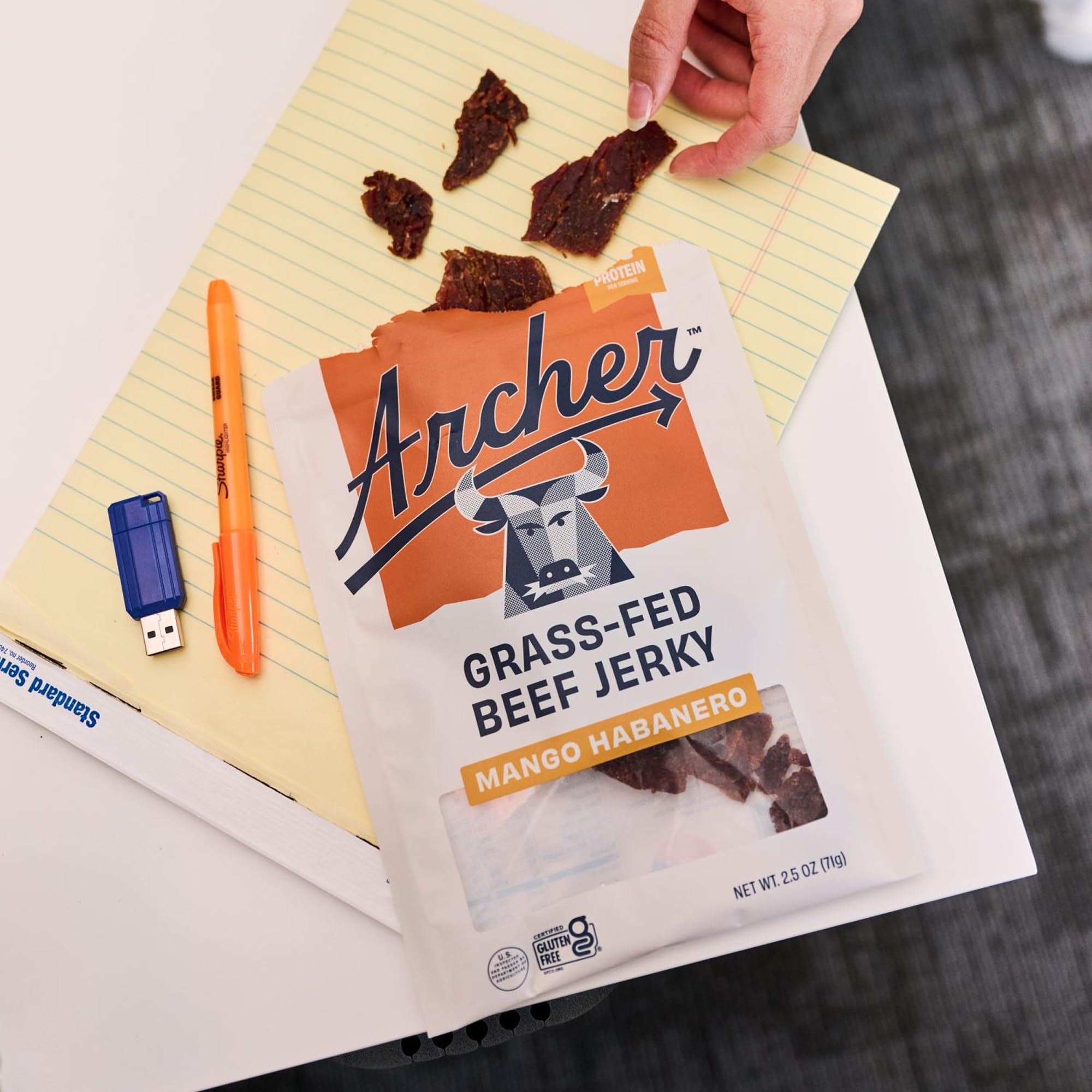 Country Archer Teriyaki jerky slice on a tray with a glossy glaze.