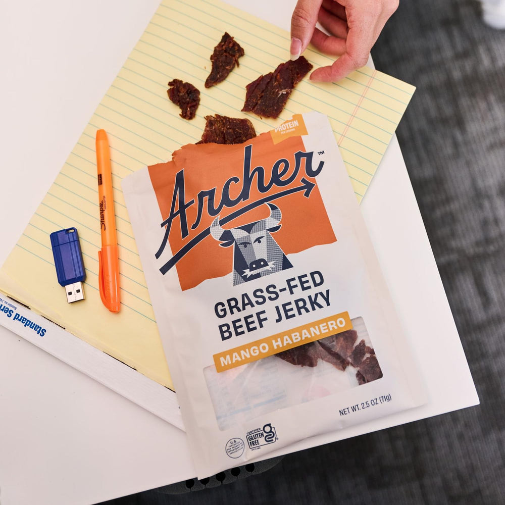 Country Archer Teriyaki jerky slice on a tray with a glossy glaze.