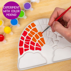 Creative Roots color-mixing exploration on stone for vibrant palettes.