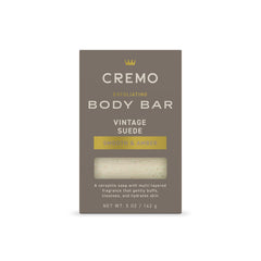 Cremo Vintage Suede Exfoliating Bar front close-up with textured lava rock.