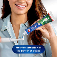 Brushing action using Crest toothpaste emphasizes cavity protection and tartar control.