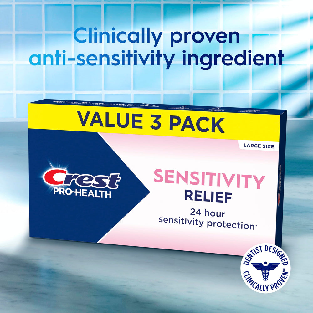 Crest Sensitivity Relief toothpaste being held to emphasize enamel strengthening.