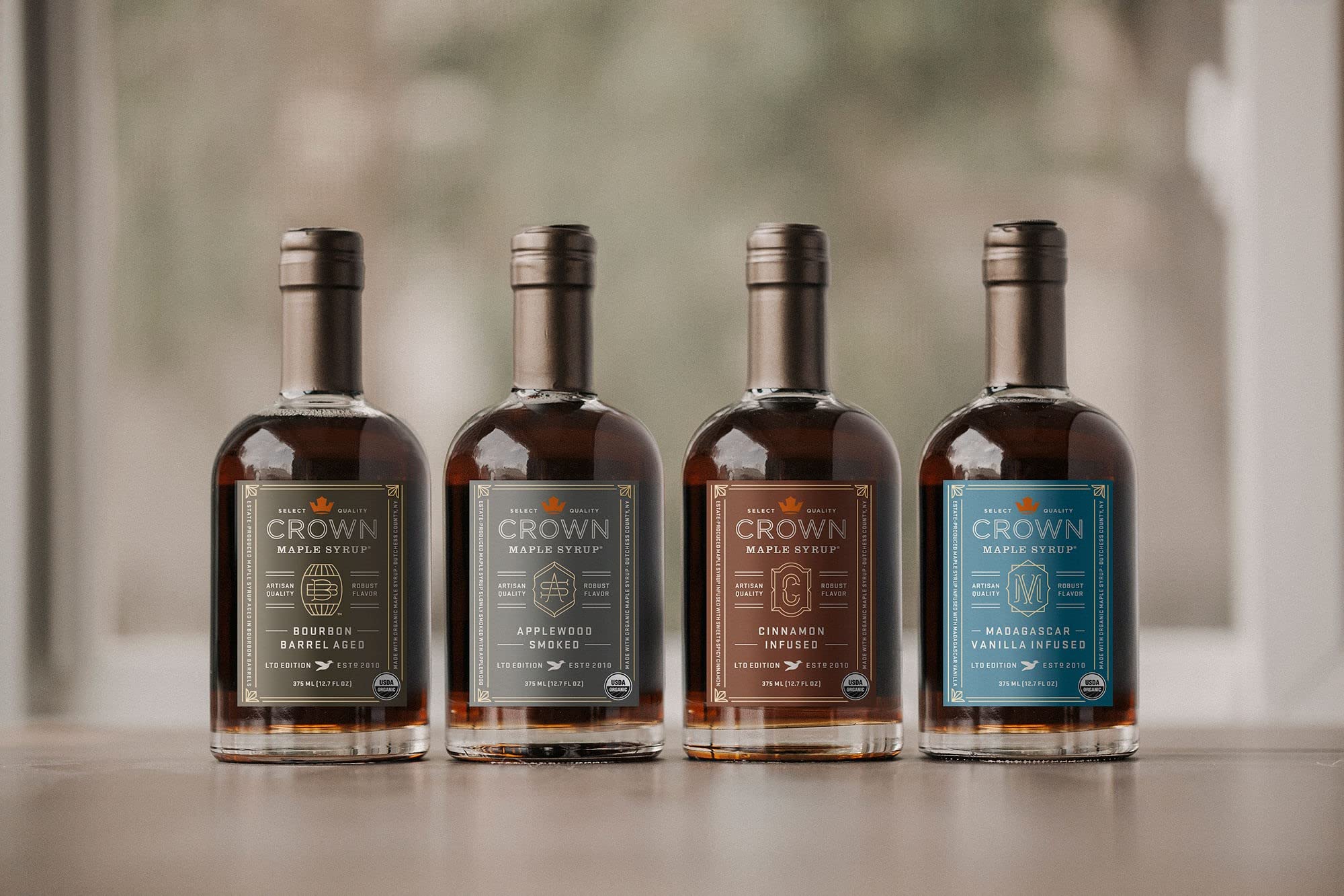 Crown Maple vanilla-infused syrup kitchen scene suggests gourmet ingredient for baking and sipping.