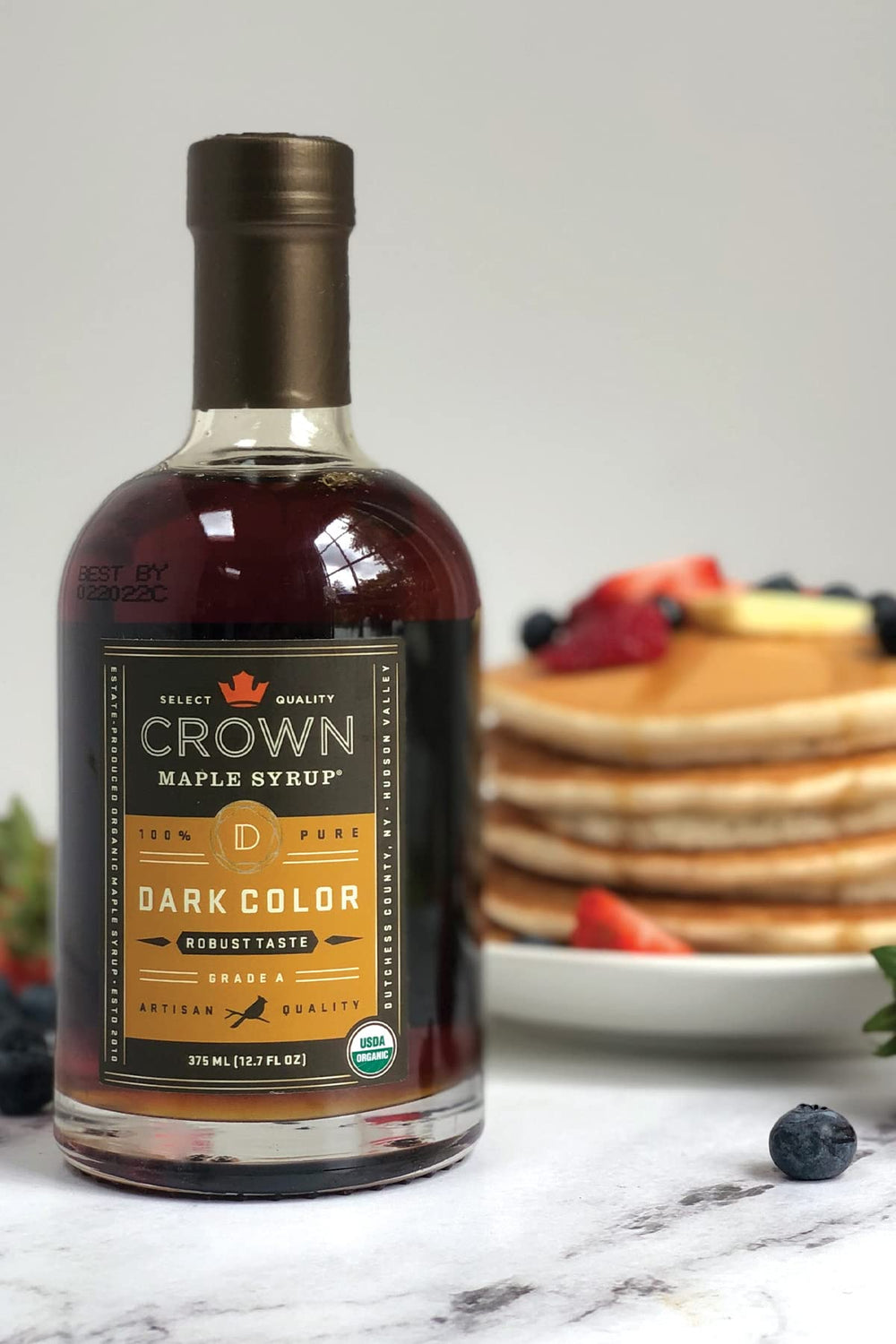 Crown Maple sourcing forest image emphasizes estate-crafted organic authenticity.