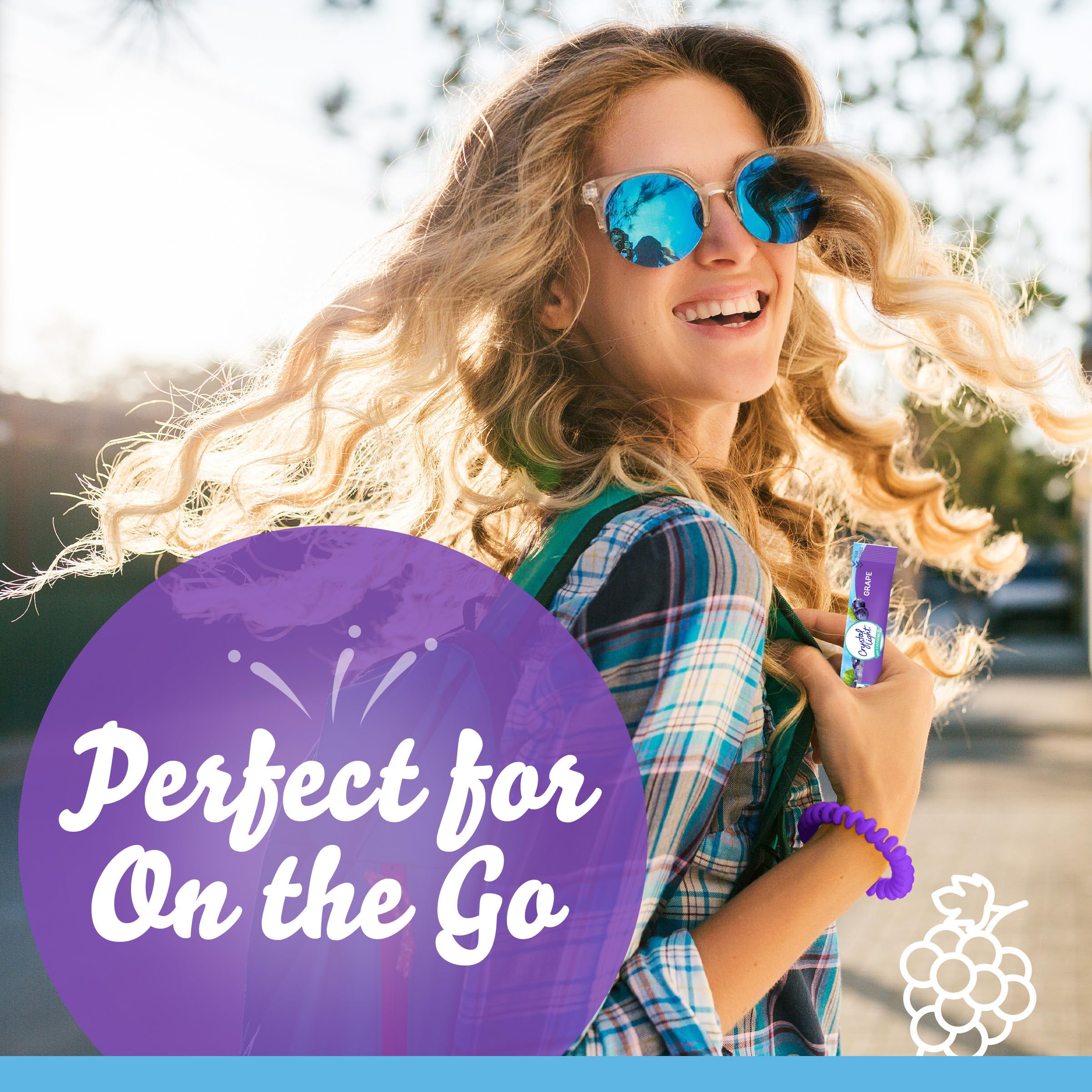 Crystal Light Grape on-the-go packets beside a water bottle for easy use.