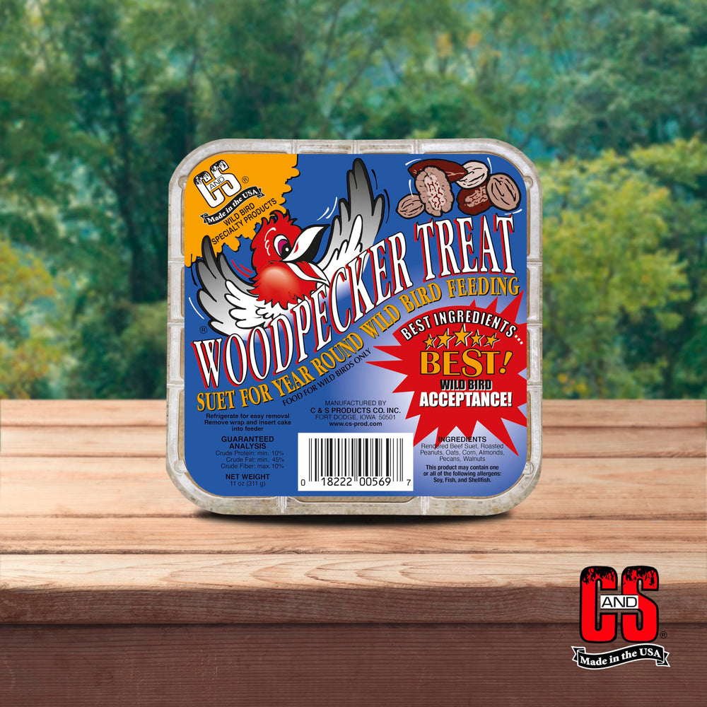 Birds flock to C&S Woodpecker Suet Cake in a tree.