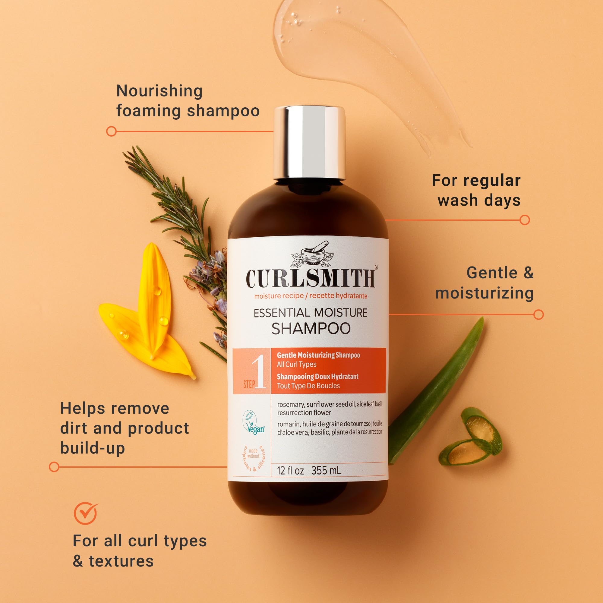 Curlsmith Essential Moisture Cleanser foamy lather in hand for hydration.