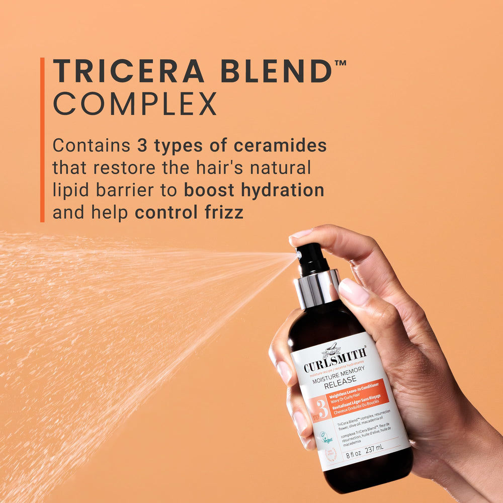 Damp hair being styled with easy distribution from the spray.