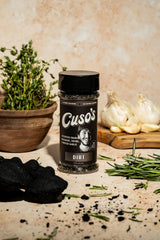 Smoked meat on the grill with Cuso Cuts Dirt rub.