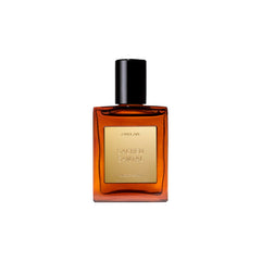 CYKLAR Sacred Santal perfume oil bottle pour reveals warm amber notes.