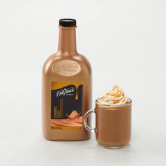 DaVinci Gourmet Classic Caramel Sauce pours smoothly from a bottle onto a cup