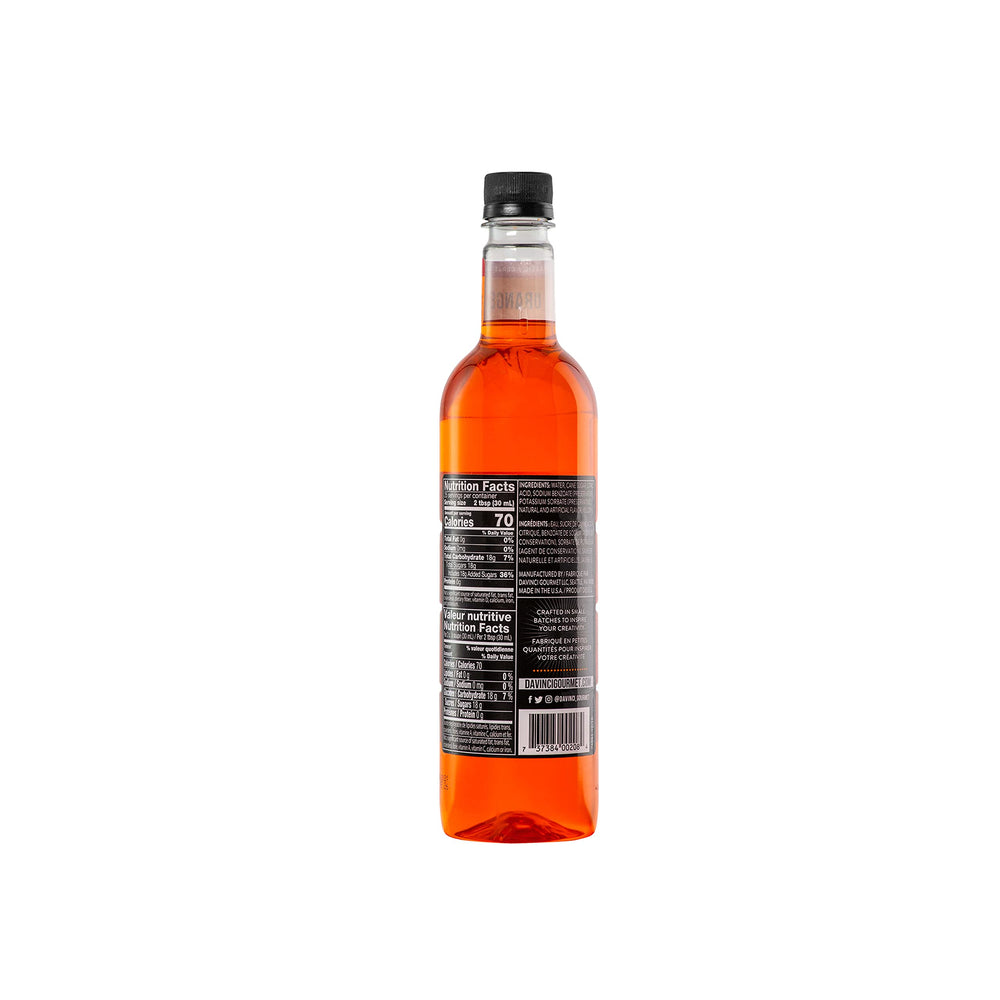 Pouring DaVinci Gourmet Classic Orange Syrup into a glass to elevate cocktails