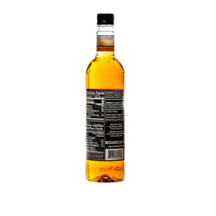 Pouring DaVinci Gourmet sugar-free caramel syrup into coffee for a rich caramel note