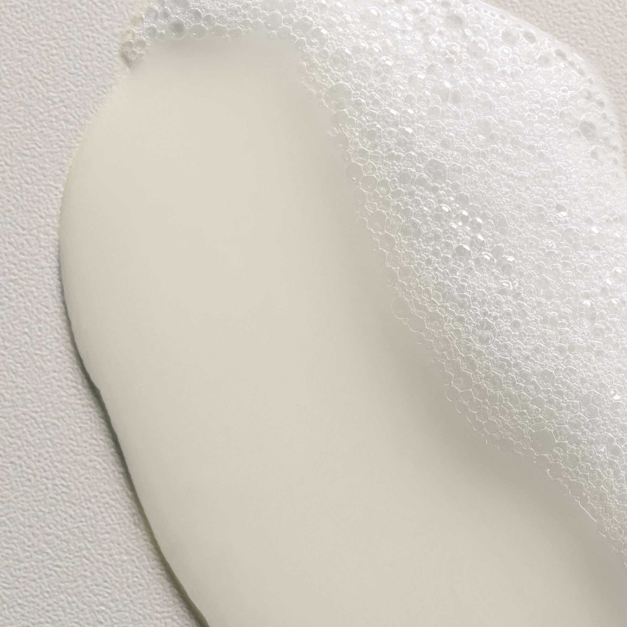 Davines Love Curl Shampoo foam close-up showing creamy lather for textured hair.