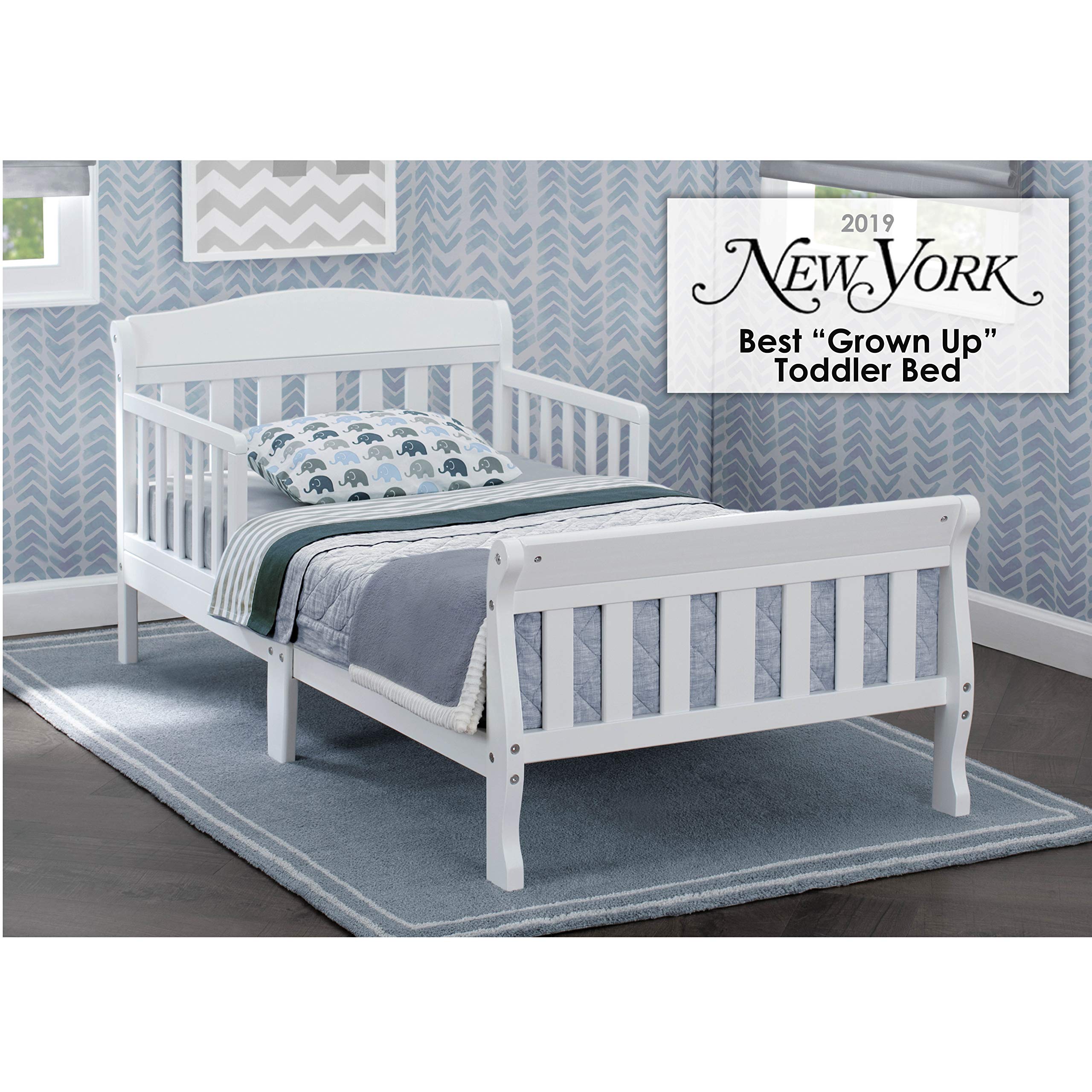 Delta Children Canton Toddler Bed White side view shows sturdy wood frame.
