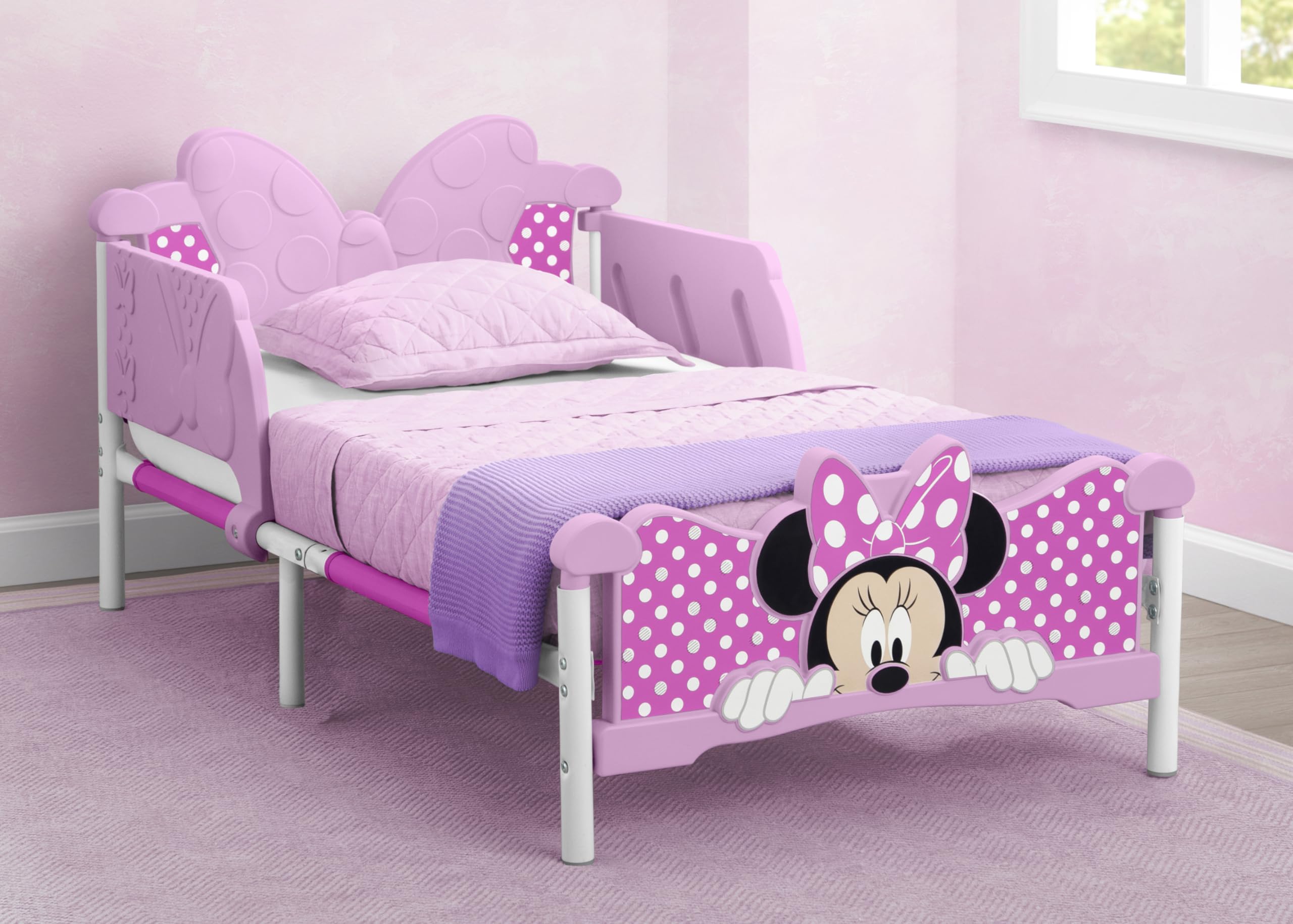 Delta Children Minnie Mouse 3D toddler bed pink footboard detail for playful dreams.