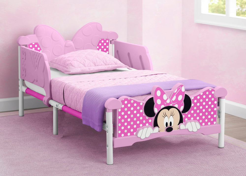 Delta Children Minnie Mouse 3D toddler bed pink footboard detail for playful dreams.