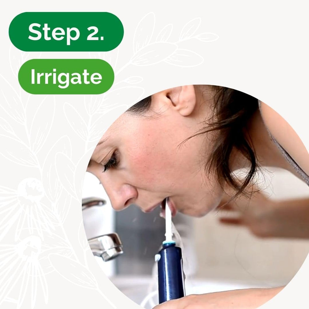 Dental Herb Under The Gums Irrigant held in hand for easy on the go care