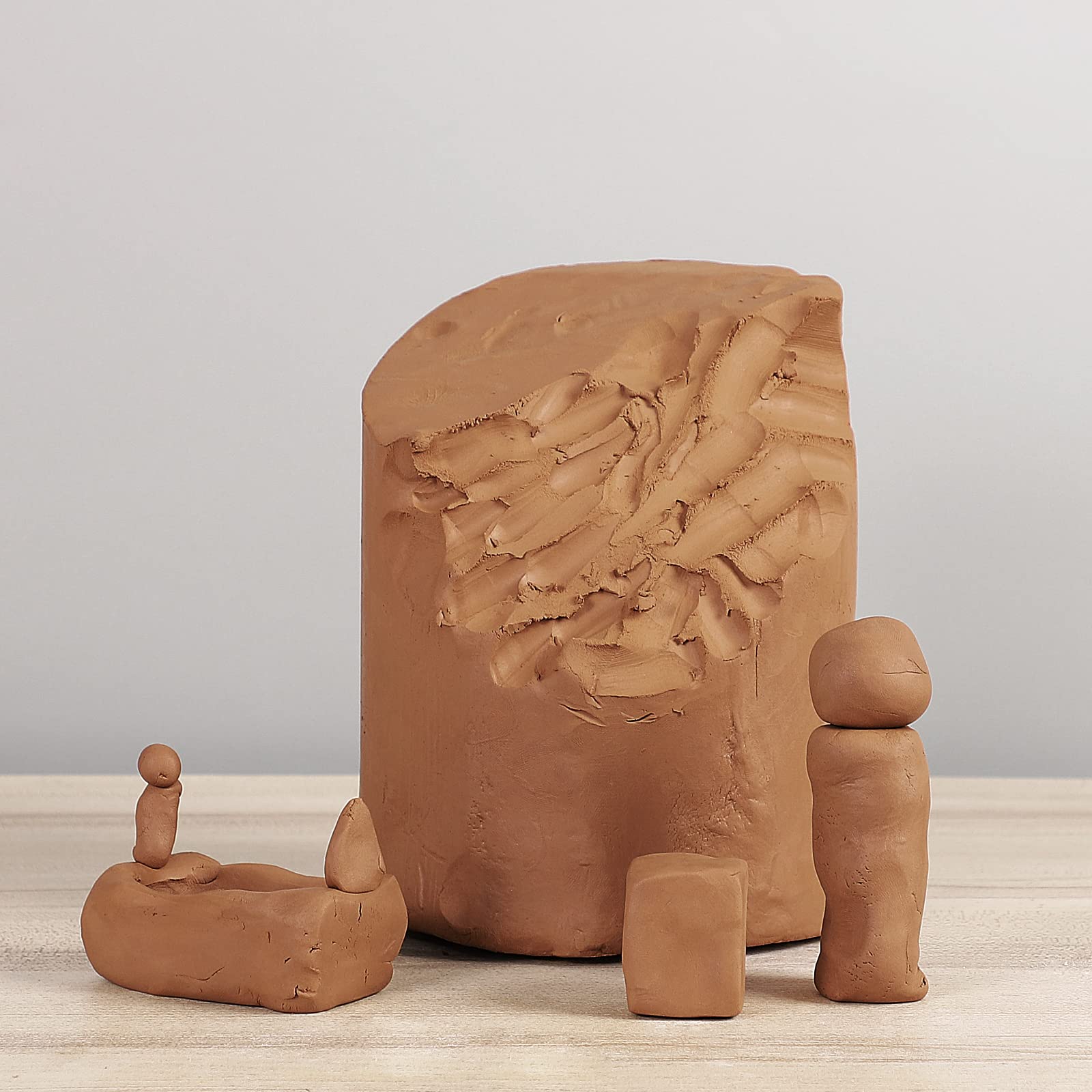 Deouss low-fire clay plasticity closeup shows smooth material ideal for handbuilt forms.