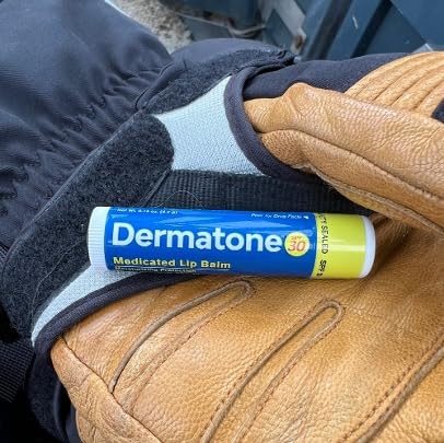 Outdoor scene with Dermatone lip balm in use during skiing