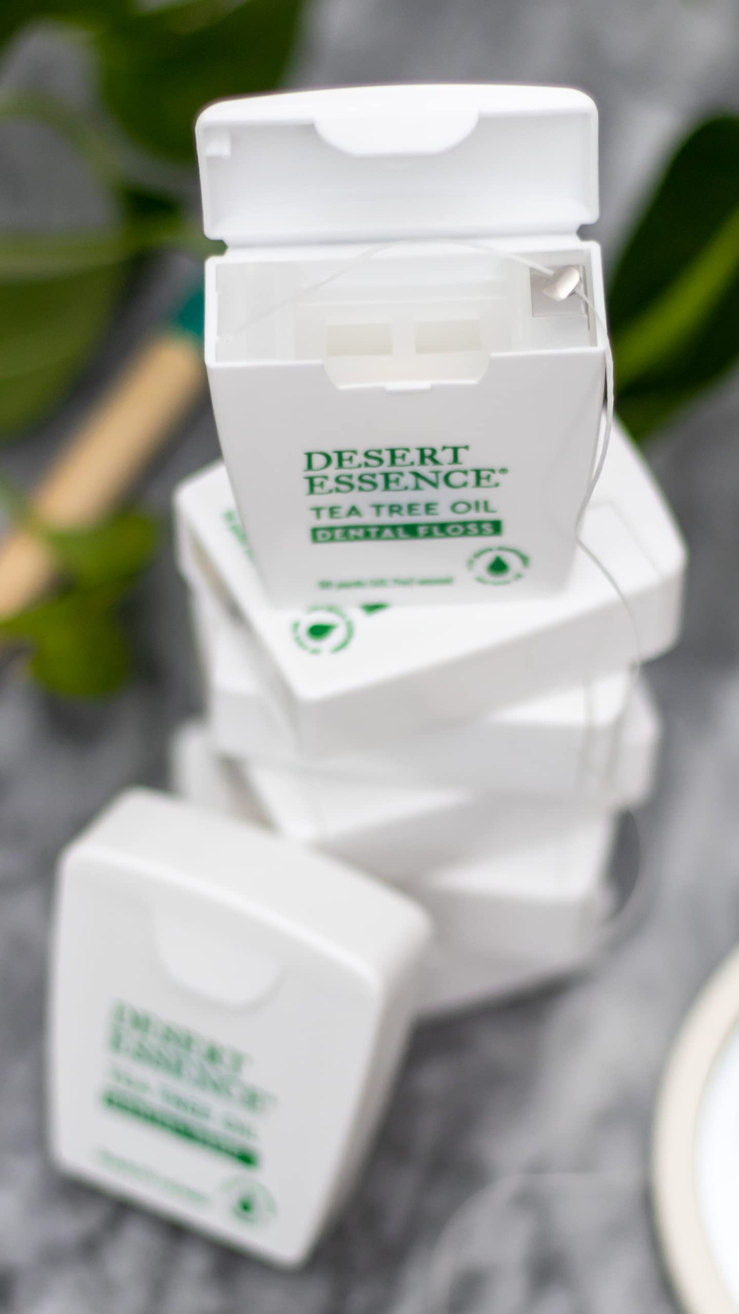 Close-up of Desert Essence floss in use.