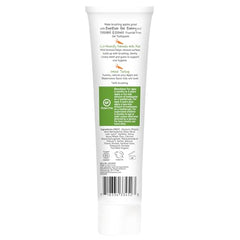 Desert Essence toothpaste dispensed on a kid's brush with gentle care.