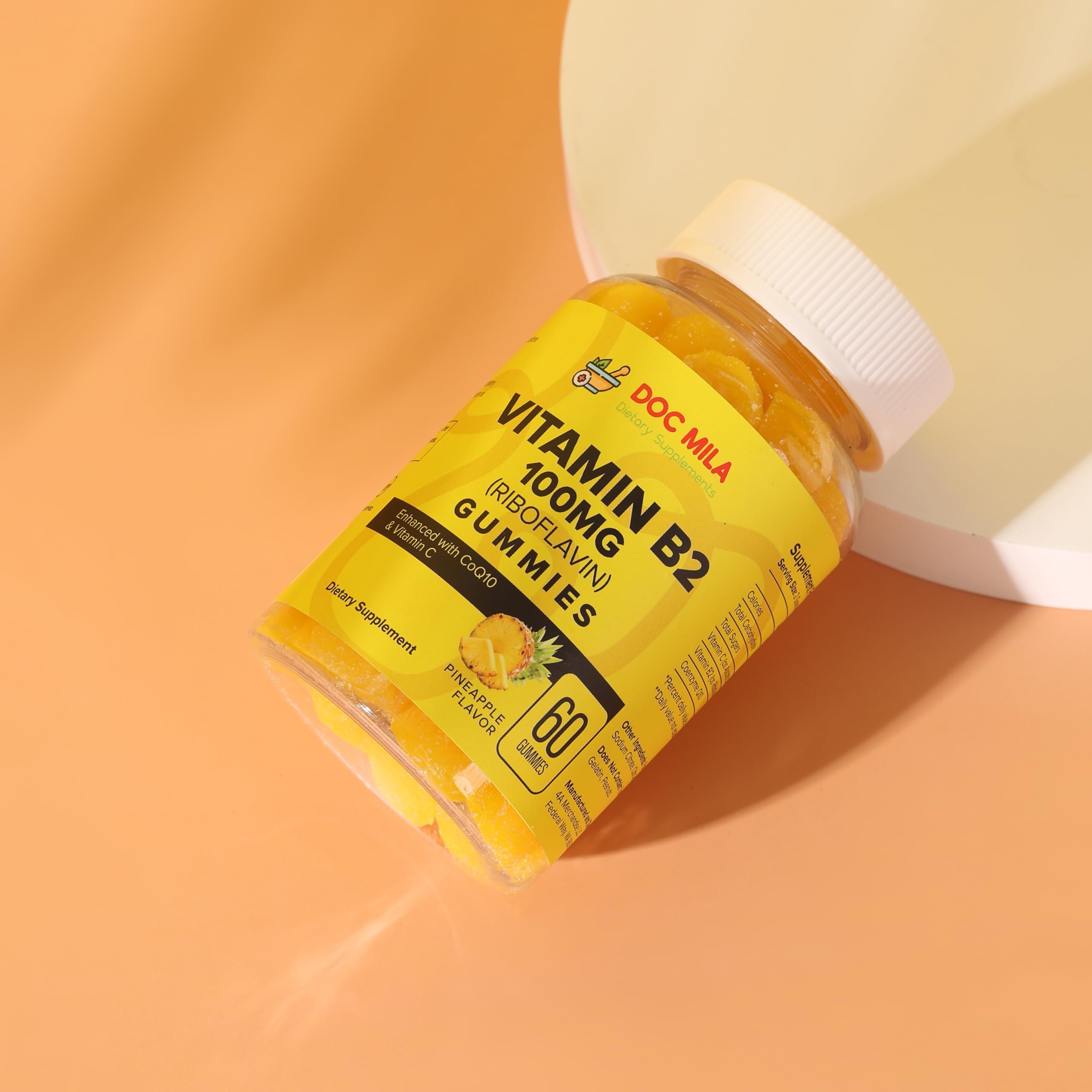 Doc Mila Vitamin B2 gummies pineapple flavor label indicating 100 mg per serving.