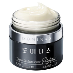 Dominas Dark Spot Corrector Cream tube closeup shows smooth texture and potential even tone for daily care.