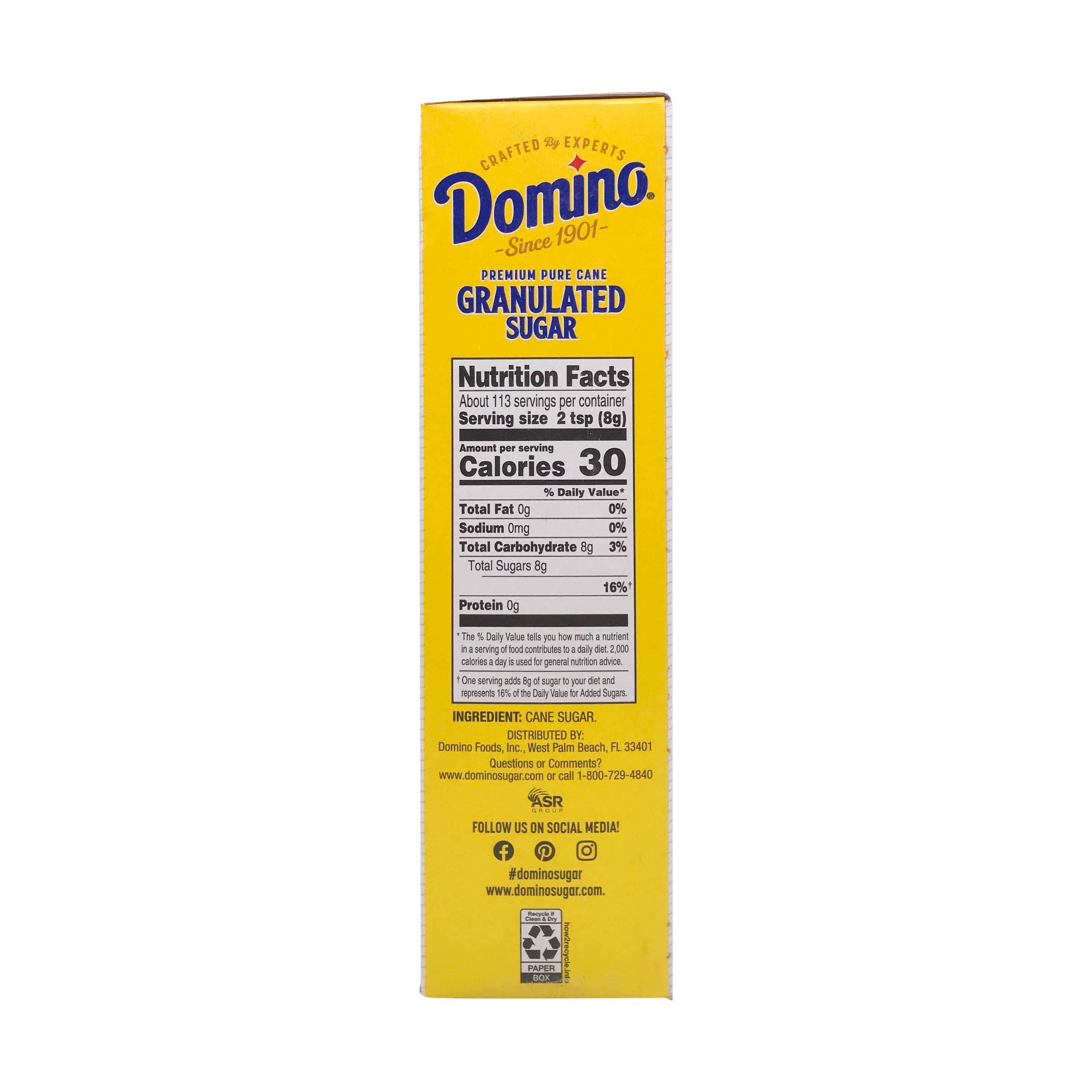 Domino Cane Sugar scooped on spoon showcasing crystalline texture