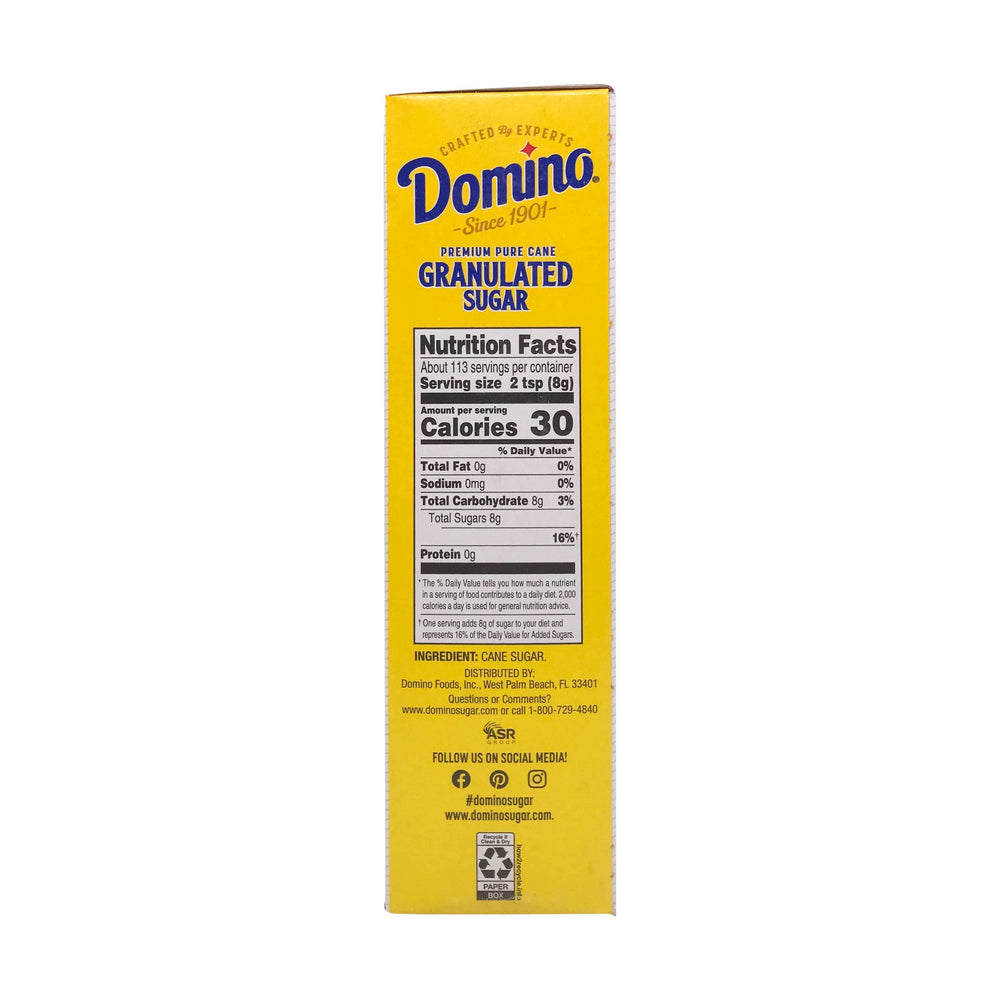 Domino Cane Sugar scooped on spoon showcasing crystalline texture