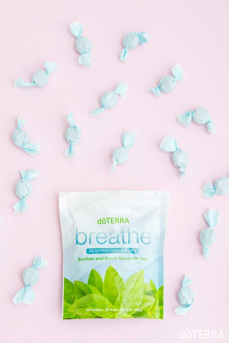 Drops dissolving on the tongue, releasing a refreshing essential oil blend.
