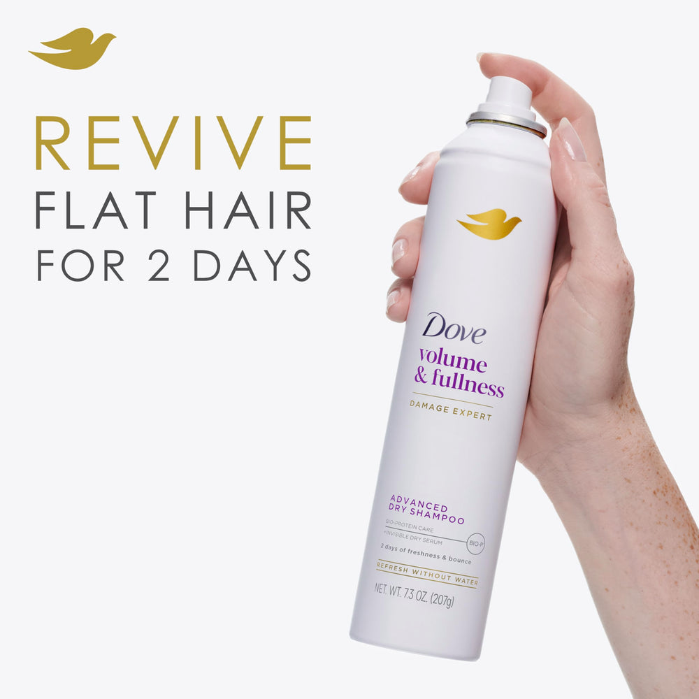 Dove Advanced Dry Shampoo being sprayed near roots for volumizing refresh.