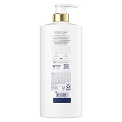 Hands applying Dove Intensive Repair conditioner for daily nourishment.