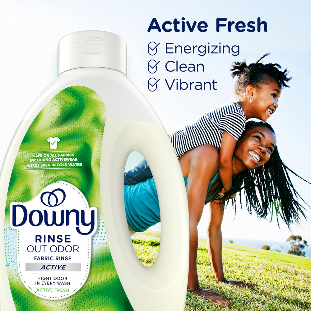 Towels and clothes refreshed by Downy Rinse in a home setting.