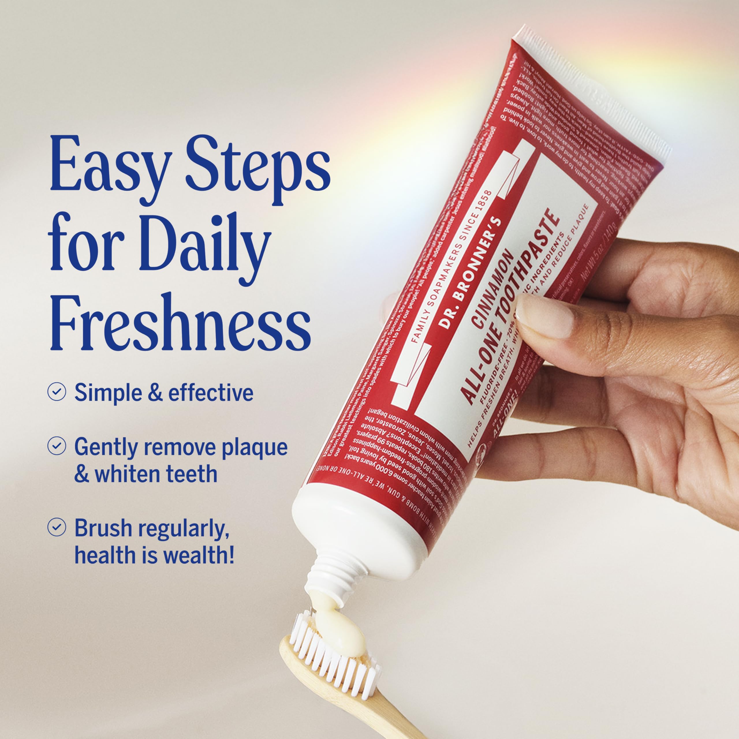 Dr. Bronner's All-One Cinnamon toothpaste on a toothbrush demonstrates foaming control.