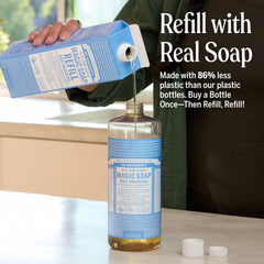 Pouring Dr. Bronner's Pure-Castile soap for versatile refilling.