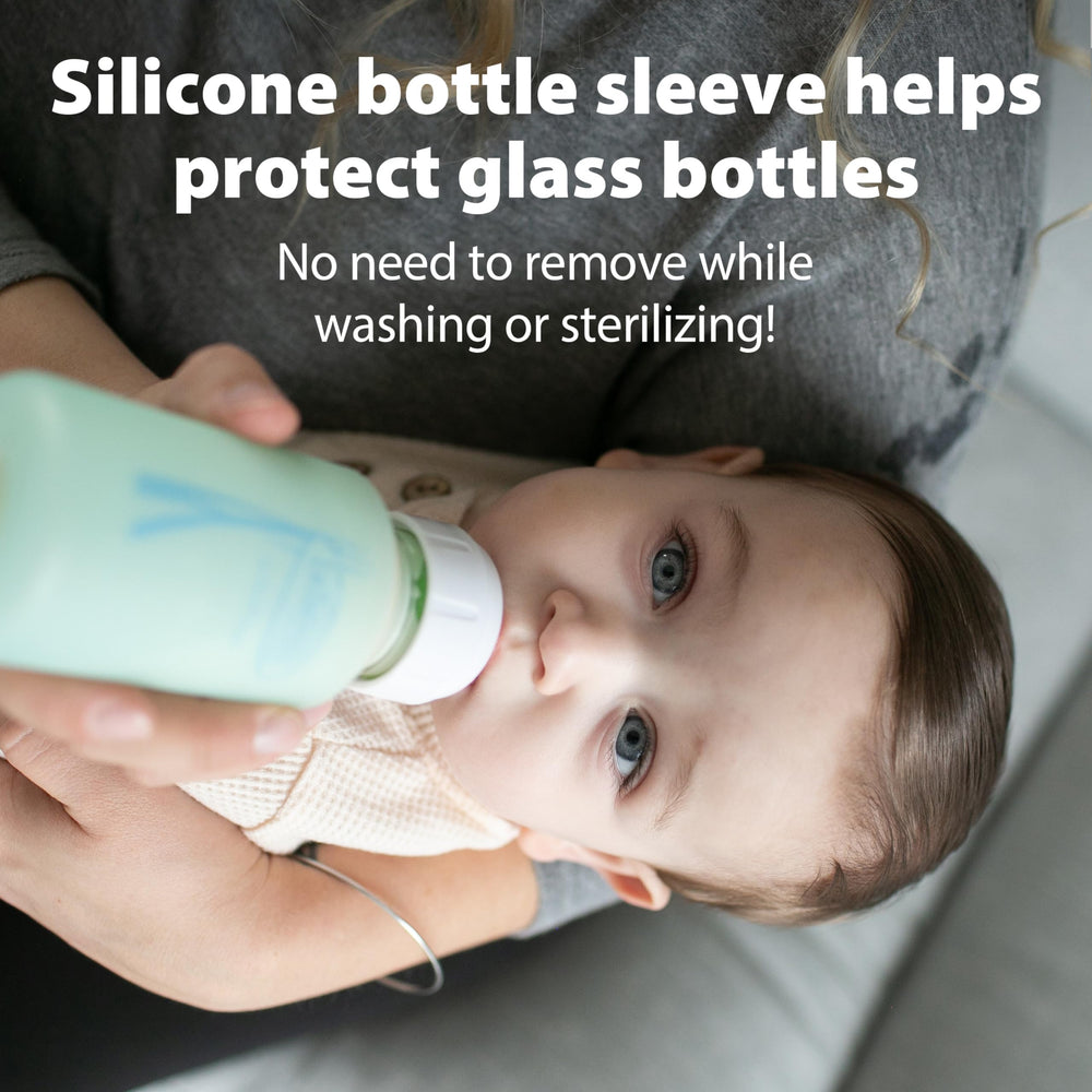 Dr. Brown's bottle beside a breast during transition for natural feeding