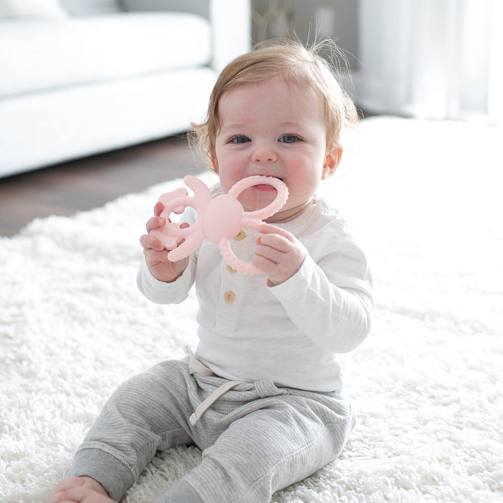 Dr. Brown's Flexees Bunny Teether ears bending to reach molars for comfort.