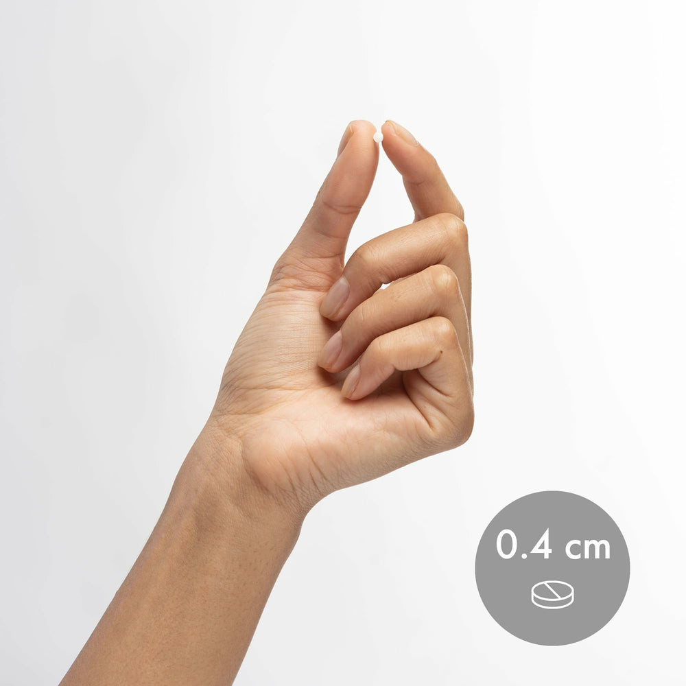Dr. Mercola Niacinamide 50mg bottle beside a glass