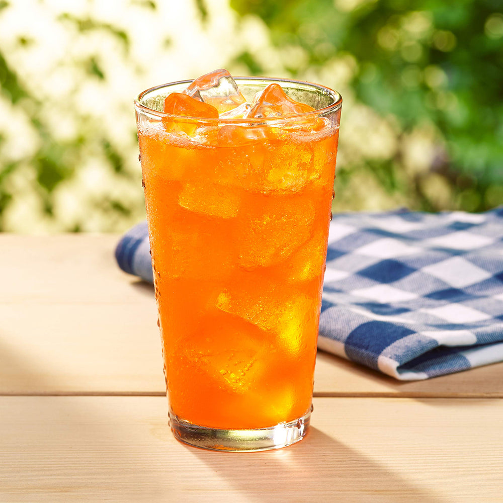 Dr Pepper Sunkist Zero Sugar orange soda glass angled, bold orange aroma ready to sip.