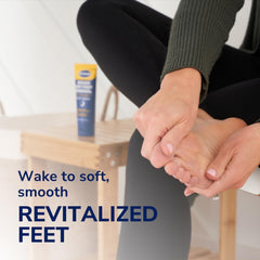 Applying Dr. Scholl's foot-renewal cream before bed for nightly care.