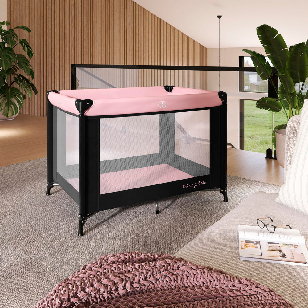 Dream On Me Nest portable playard with mesh sides for 360-degree ventilation and visibility.